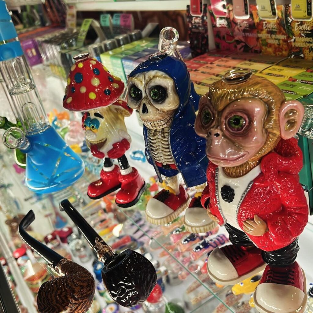 Colorful glass skull monkey and mushroom character pieces from Stinky Familia, showcasing intricate designs and vibrant colors.