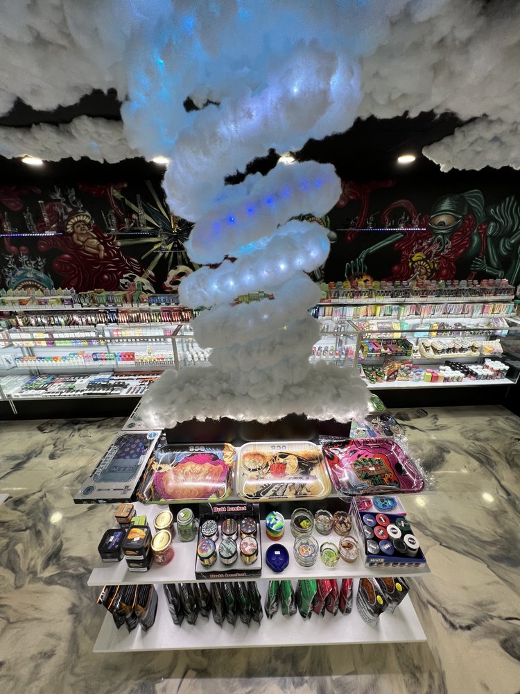 Colorful Thunder Cloud aerial view of Stinky Familia smoke shop in Elk Grove Village, showcasing its vibrant exterior and inviting atmosphere for eco-friendly smoking accessories.